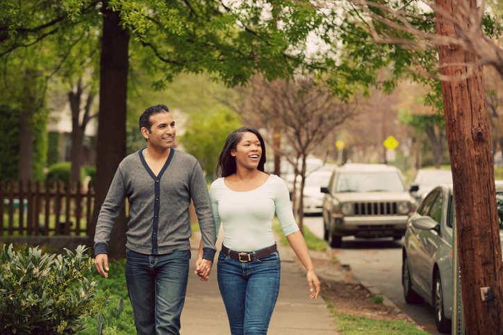 Happy couple walking around the park