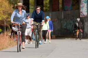 Guy and woman riding a bike