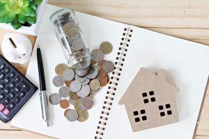 wood house model and coins