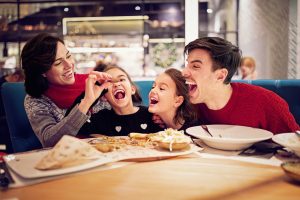 happy family dinning in a restaurant